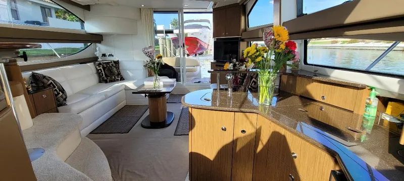 Slide: The Image of Luxurious interior of a 2016 Meridian 391 Sedan yacht with elegant furnishings and floral decor. - 20