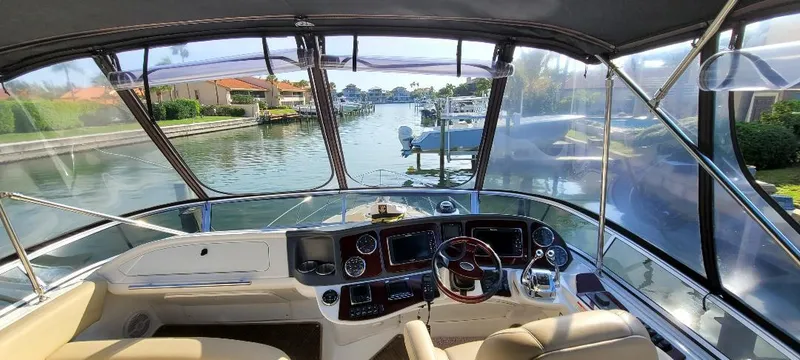 Slide: The Image of 2016 Meridian 391 Sedan yacht cockpit with waterfront view, featuring modern navigation controls. - 21