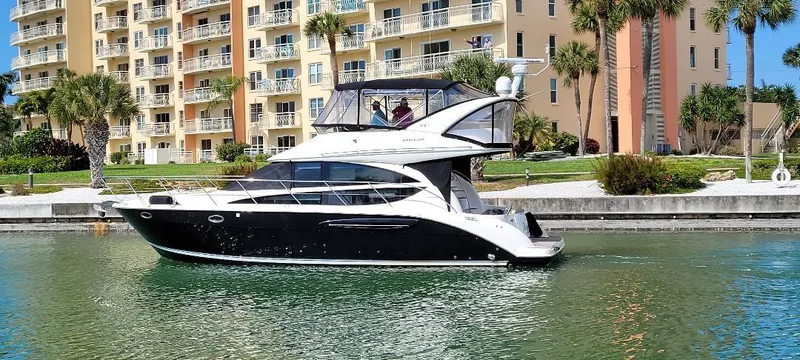 Slide: The Image of 2016 Meridian 391 Sedan yacht cruising near waterfront apartments. - 3