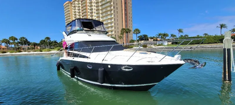 Slide: The Image of 2016 Meridian 391 Sedan yacht docked near a waterfront building. - 4