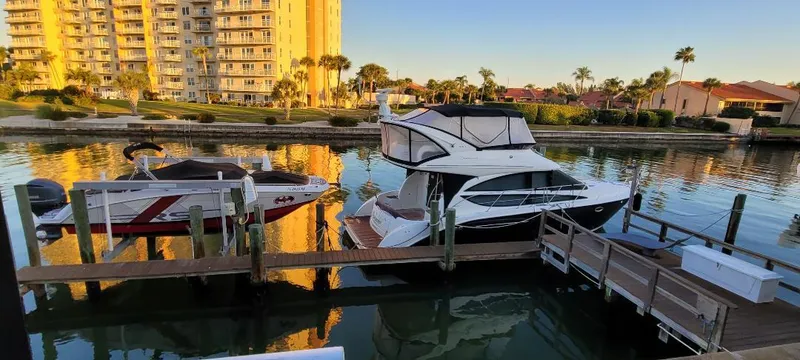 Slide: The Image of 2016 Meridian 391 Sedan docked in a scenic marina with waterfront buildings. - 6