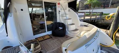 Slide: The Image of 2016 Meridian 391 Sedan yacht deck with seating, stairs, and dock view. - 7
