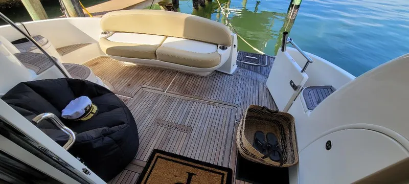 Slide: The Image of 2016 Meridian 391 Sedan yacht deck with seating, wicker basket, and nautical decor. - 9