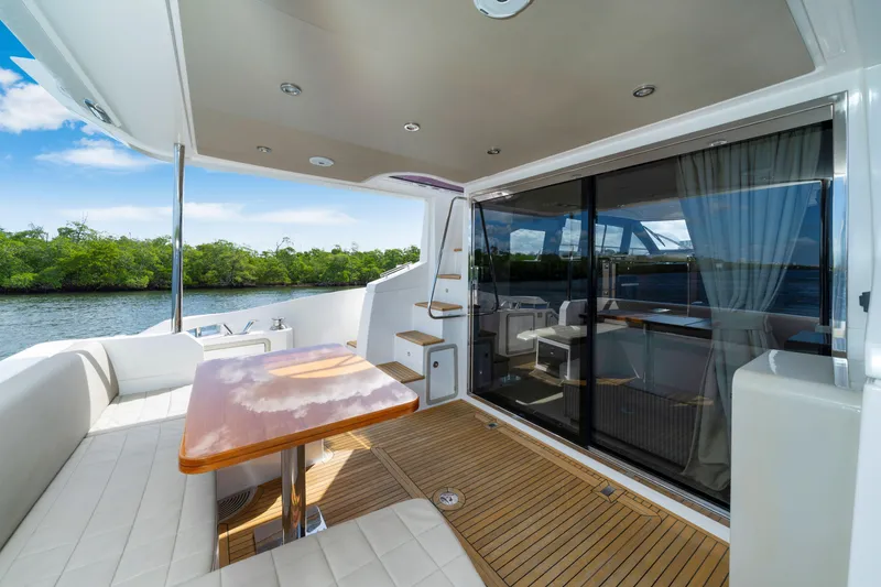 Slide: The Image of Luxurious 2018 Azimut 50 Fly yacht with elegant outdoor seating and scenic water view. - 11