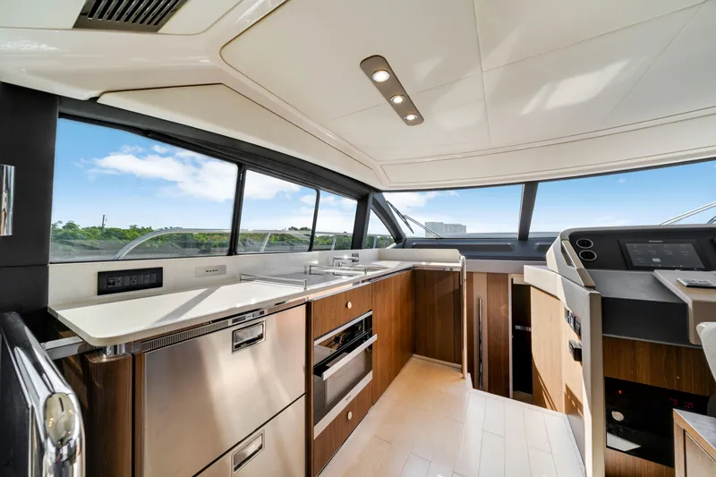 Slide: The Image of Luxurious interior of 2018 Azimut 50 Fly yacht with modern kitchen and panoramic windows. - 19