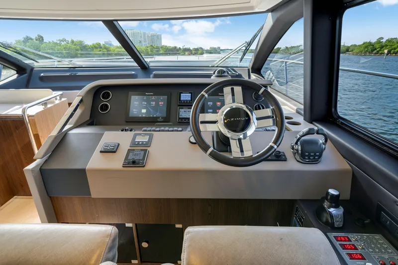 Slide: The Image of 2018 Azimut 50 Fly yacht helm with modern controls and navigation displays. - 23