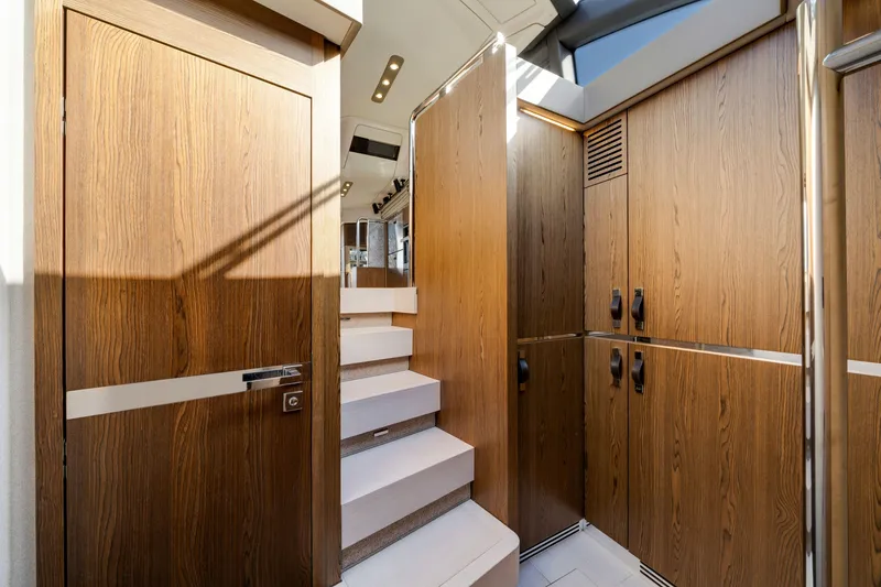 Slide: The Image of Interior of 2018 Azimut 50 Fly yacht with wooden cabinetry and stairs. - 25