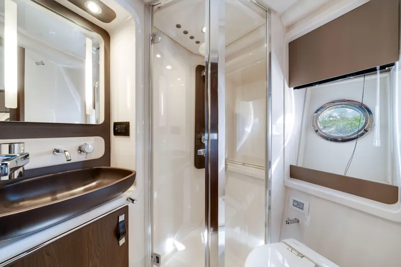 Slide: The Image of Luxurious bathroom interior of 2018 Azimut 50 Fly yacht with modern fixtures and porthole window. - 33