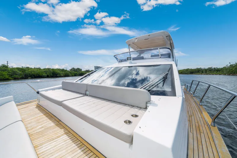 Slide: The Image of 2018 Azimut 50 Fly yacht on a serene river, featuring sleek design and spacious deck. - 44
