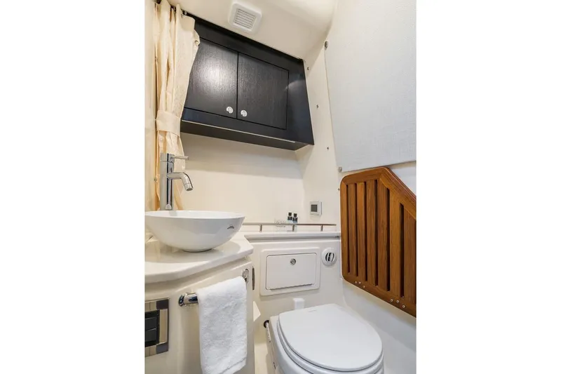 Slide: The Image of Manufacturer Provided Image: Luxurious bathroom in 2026 Boston Whaler 380 Realm boat, featuring modern fixtures and elegant design. - 14
