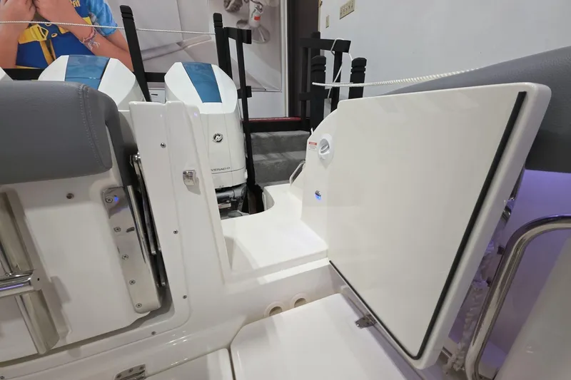 Slide: The Image of 2026 Boston Whaler 380 Realm boat interior with open access door and visible engine. - 20