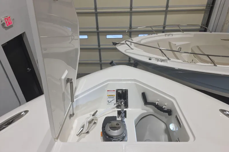 Slide: The Image of 2026 Boston Whaler 380 Realm anchor compartment in a showroom setting. - 22