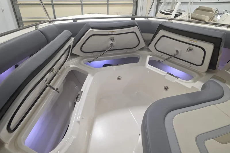 Slide: The Image of 2026 Boston Whaler 380 Realm interior with open storage compartments and ambient lighting. - 24
