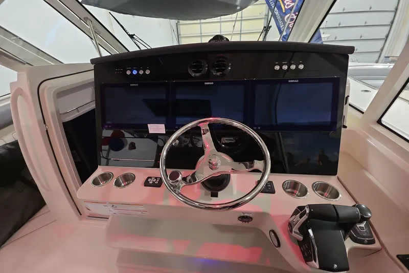 Slide: The Image of Helm of 2026 Boston Whaler 380 Realm with advanced navigation displays and controls. - 27