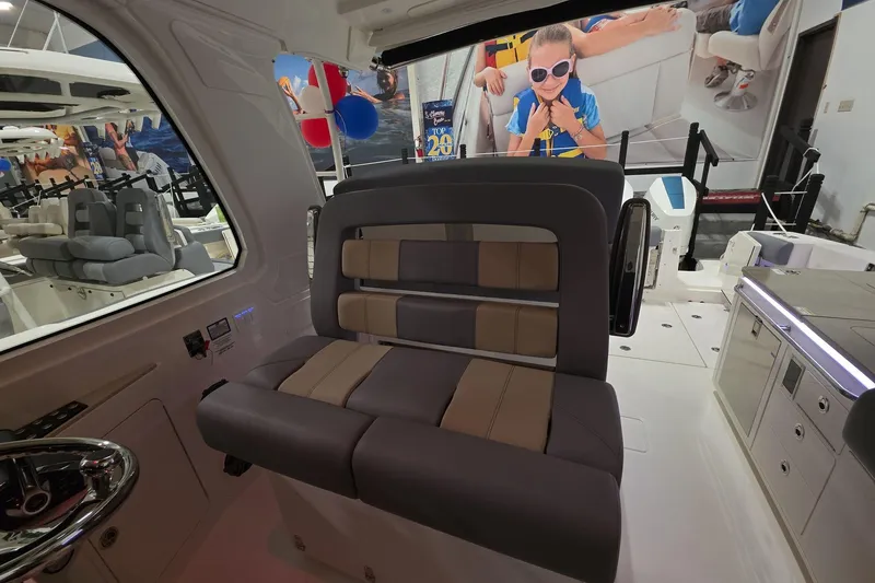 Slide: The Image of Interior of 2026 Boston Whaler 380 Realm with modern seating and vibrant display. - 29
