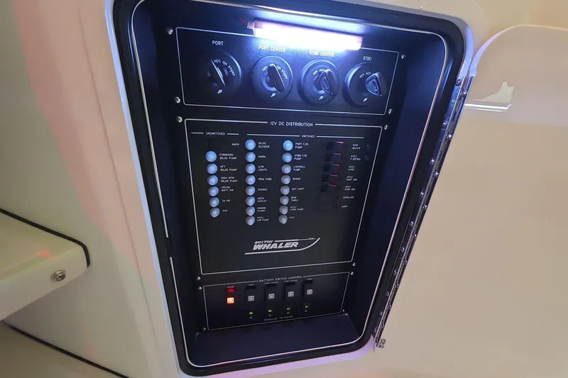 Slide: The Image of Control panel of 2026 Boston Whaler 380 Realm boat, featuring switches and indicators. - 32