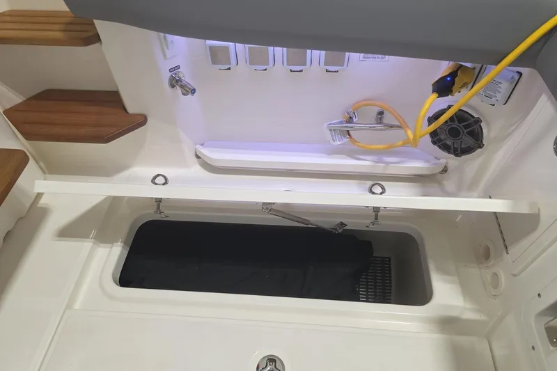 Slide: The Image of Interior view of 2026 Boston Whaler 380 Realm boat, featuring storage and utility area. - 35