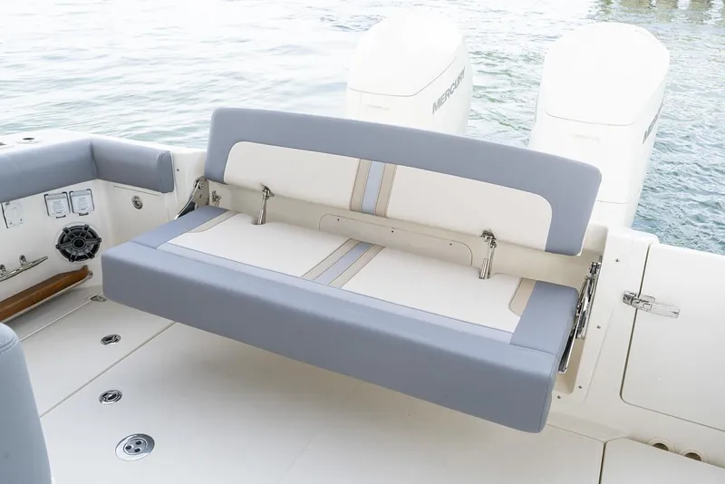 Slide: The Image of Manufacturer Provided Image: 2026 Boston Whaler 380 Realm boat seat with dual engines in the background. - 9