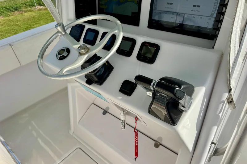 Slide: The Image of 2010 Venture 34 Tournament boat dashboard with steering wheel and control panel. - 10
