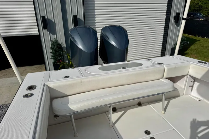 Slide: The Image of 2010 Venture 34 Tournament boat with dual engines and white seating in a storage area. - 12