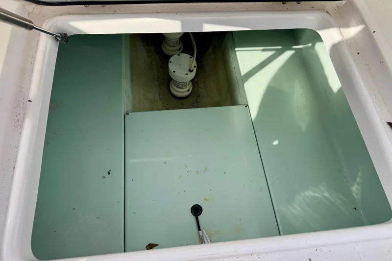 Slide: The Image of Open storage compartment in 2010 Venture 34 Tournament boat. - 13