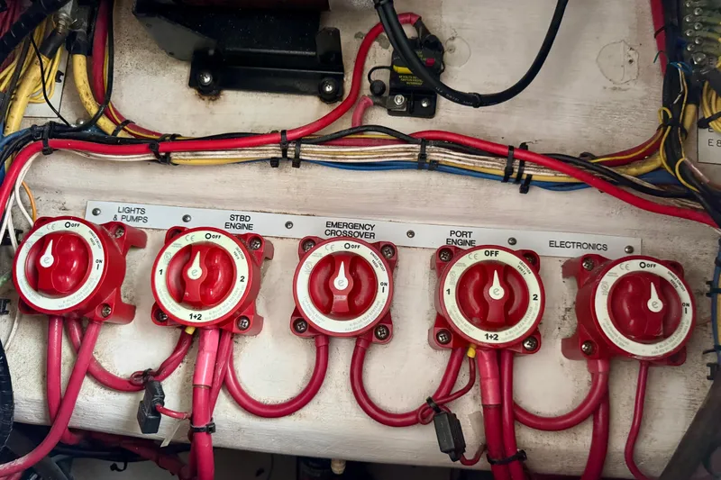 Slide: The Image of Electrical panel with red switches and wiring on a 2010 Venture 34 Tournament boat. - 14
