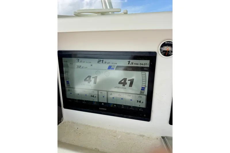 Slide: The Image of Garmin marine display on 2010 Venture 34 Tournament boat dashboard, showing speed and fuel data. - 15