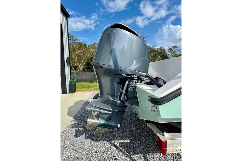 Slide: The Image of 2010 Venture 34 Tournament boat engine, parked outdoors on gravel driveway. - 4