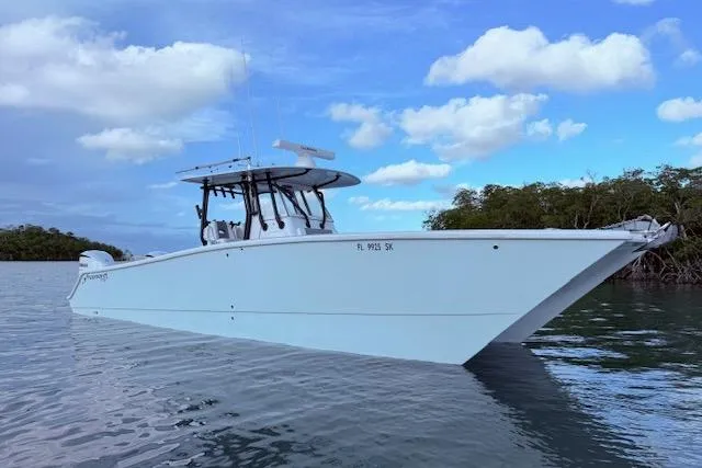 Slide: The Image of 2019 Freeman 34 boat on calm water under a partly cloudy sky. - 0