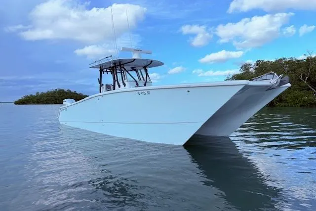 Slide: The Image of 2019 Freeman 34 boat on calm water under a partly cloudy sky. - 1