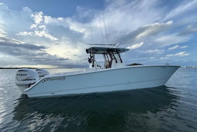 Slide: The Image of 2019 Freeman 34 boat on calm water under a cloudy sky. - 12