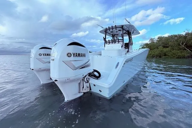 Slide: The Image of 2019 Freeman 34 boat with twin Yamaha engines on calm water. - 16