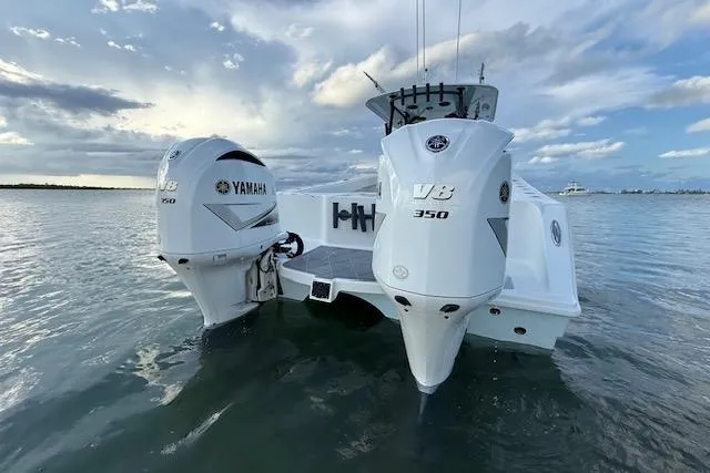 Slide: The Image of 2019 Freeman 34 boat with twin Yamaha V8 350 engines on calm water. - 17
