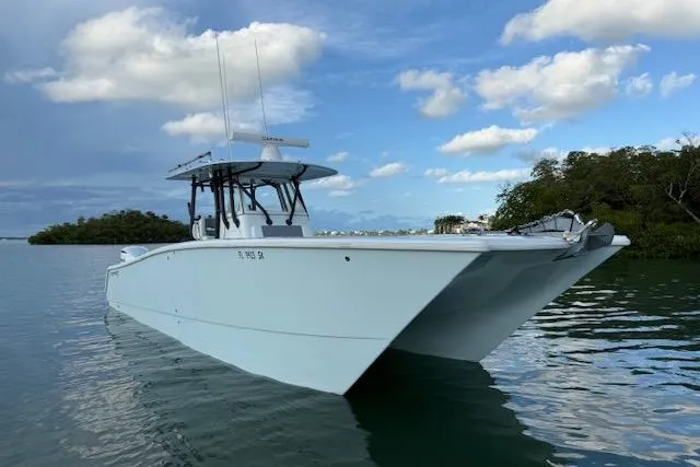 Slide: The Image of 2019 Freeman 34 boat on calm water under a partly cloudy sky. - 2