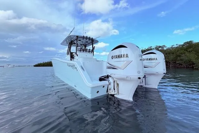 Slide: The Image of 2019 Freeman 34 boat with twin Yamaha engines on calm water. - 22