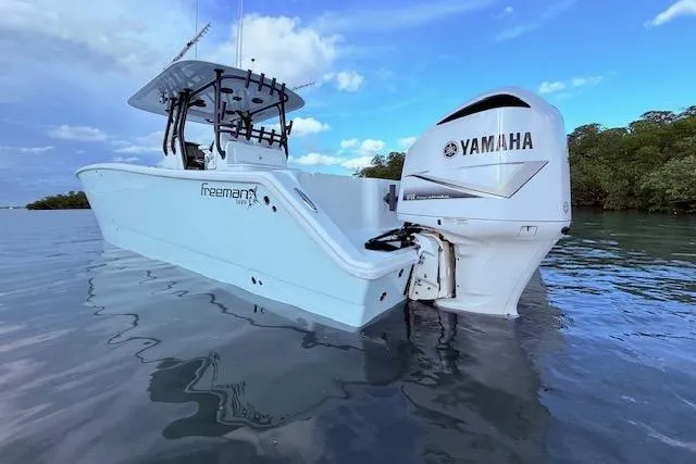Slide: The Image of 2019 Freeman 34 boat with Yamaha engine on calm water. - 23
