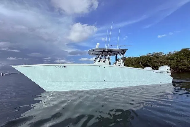 Slide: The Image of 2019 Freeman 34 boat on calm water under a cloudy sky. - 25
