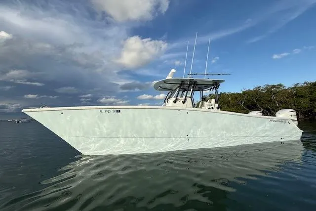 Slide: The Image of 2019 Freeman 34 boat on calm water under a partly cloudy sky. - 26