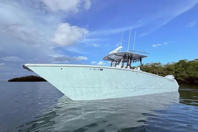 Slide: The Image of 2019 Freeman 34 boat on calm water under a blue sky. - 27
