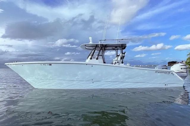 Slide: The Image of 2019 Freeman 34 boat on calm water under a partly cloudy sky. - 30