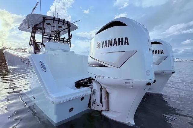 Slide: The Image of 2019 Freeman 34 boat with twin Yamaha outboard engines on calm water. - 33