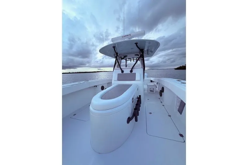 Slide: The Image of 2019 Freeman 34 boat on water under cloudy sky, featuring sleek design and modern equipment. - 34