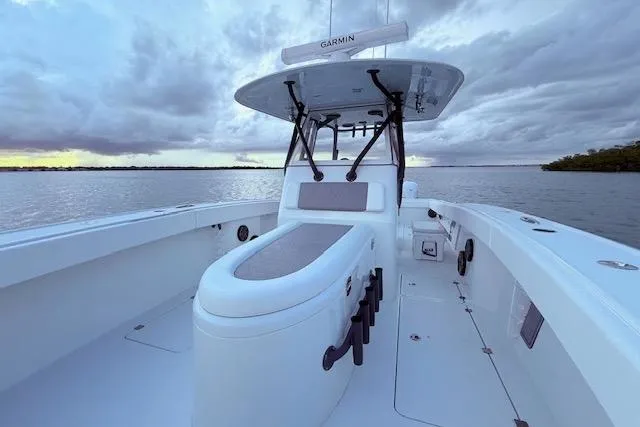 Slide: The Image of 2019 Freeman 34 boat on calm water under cloudy sky. - 35