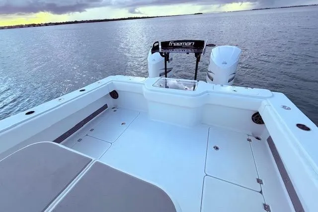 Slide: The Image of Freeman 34 boat deck, 2019 model, with dual engines on calm water. - 40