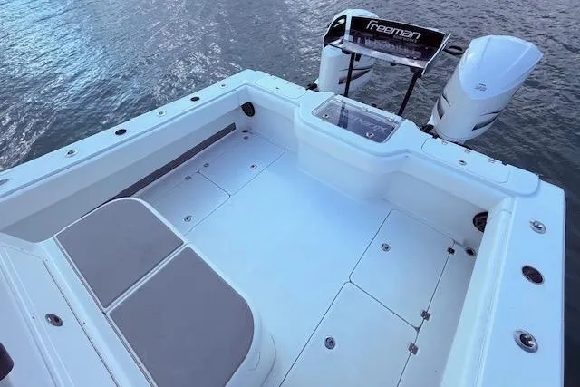 Slide: The Image of 2019 Freeman 34 boat deck with dual engines on calm water. - 42