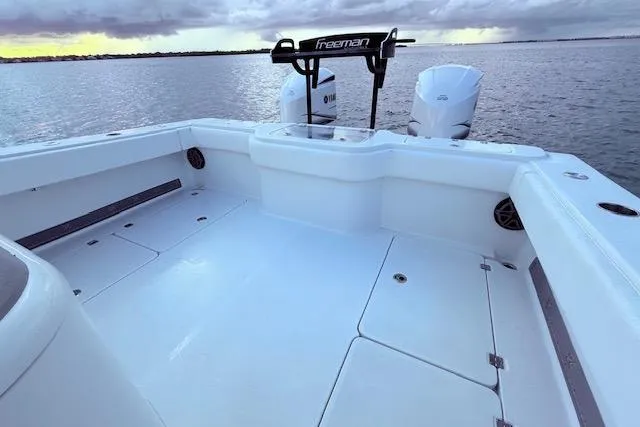 Slide: The Image of 2019 Freeman 34 boat deck with dual engines on calm water. - 43
