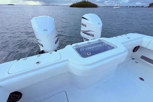 Slide: The Image of 2019 Freeman 34 boat with Yamaha engines on calm water. - 44