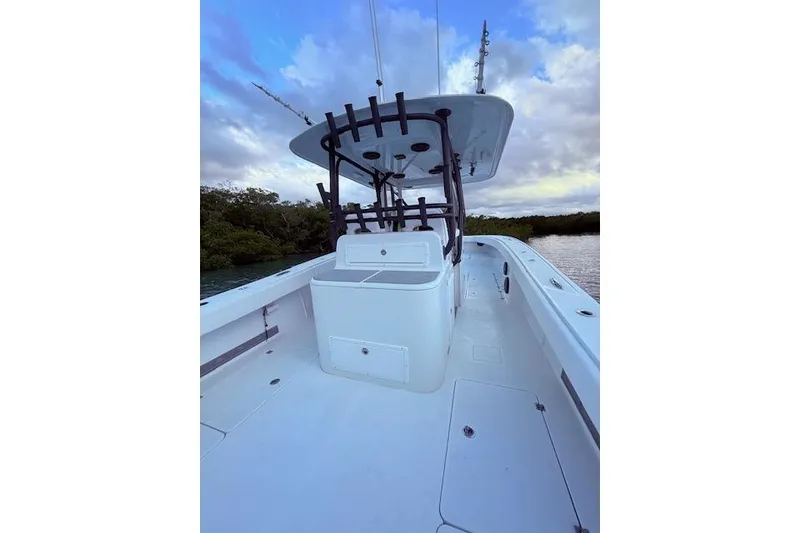 Slide: The Image of 2019 Freeman 34 boat deck with center console, under a cloudy sky. - 47