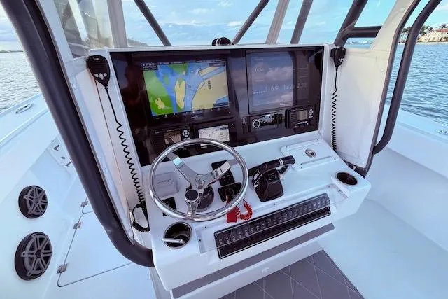 Slide: The Image of Helm of 2019 Freeman 34 boat with navigation screens and controls. - 48