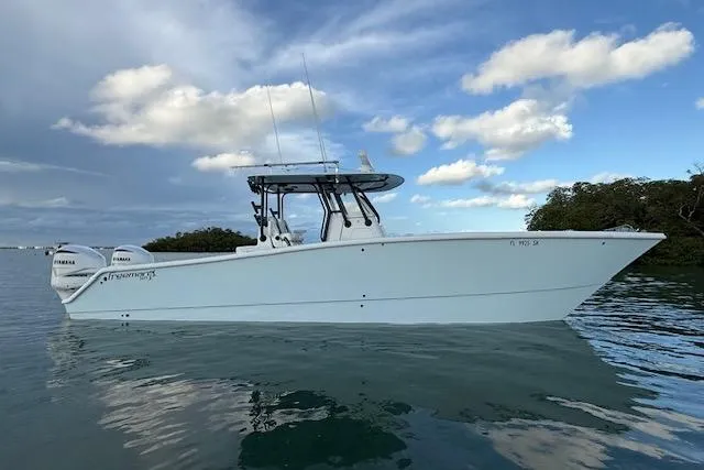Slide: The Image of 2019 Freeman 34 boat on calm water under a partly cloudy sky. - 5